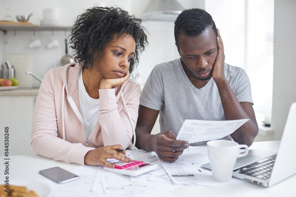 couple reviewing budget and savings plan to stop paying rent and buy a home in 2026